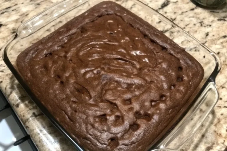 A stack of fudgy cocoa brownies with a gooey center, drizzled with melted chocolate, on a rustic wooden cutting board.