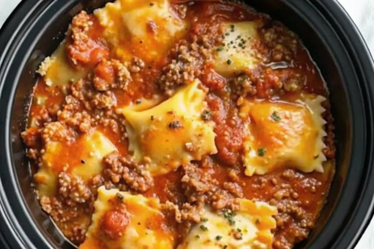 A delicious Crockpot Ravioli Lasagna with gooey melted cheese and fresh basil garnish.