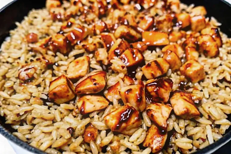 A delicious skillet of One-Pan Bold Honey BBQ Chicken Rice with golden chicken, flavorful rice, and a sticky-sweet glaze.