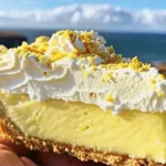 A delicious Lemon Bliss Tart with a creamy lemon filling, whipped cream topping, and crushed chocolate or lemon zest garnish