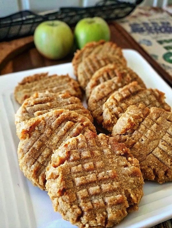 Golden brown cleanest easiest yummiest peanut butter cookies cooling on a wire rack with fork marks visible and a glass of milk nearby