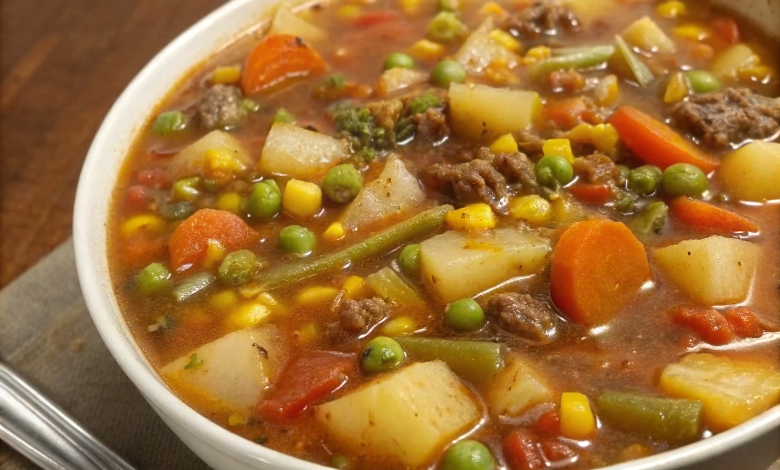 Beautifully plated hearty beef and vegetable soup in ceramic bowl with fresh parsley garnish