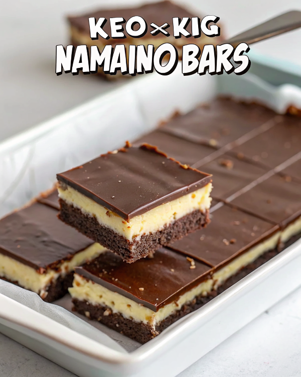 Beautiful finished keto Nanaimo bars cut into perfect squares showing distinct chocolate, vanilla, and chocolate layers on a white serving plate