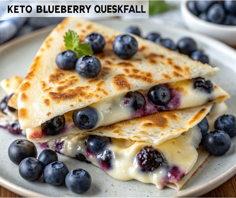 Golden crispy keto blueberry breakfast quesadilla cut into triangular pieces on a white plate, showing the creamy filling with visible blueberries, garnished with fresh berries and mint