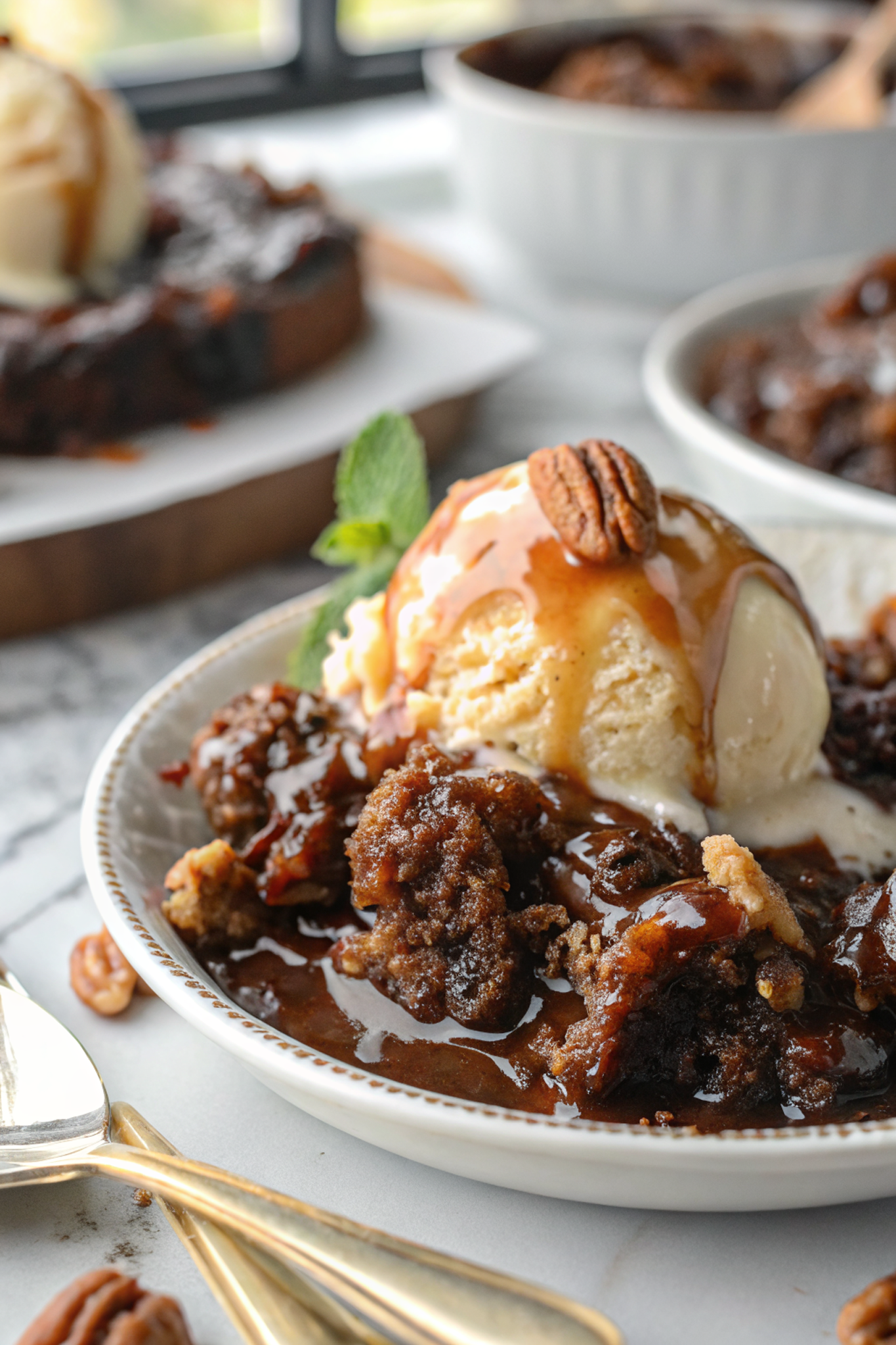 Perfect Chocolate Turtle Cobbler served warm with vanilla ice cream, showing the distinct cake top and fudgy pudding bottom layers