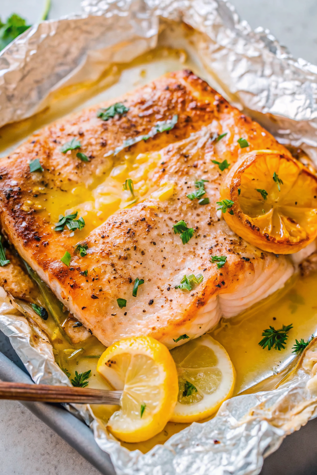 Beautifully plated Sheet Pan Lemon Garlic Butter Salmon with golden color and fresh herbs