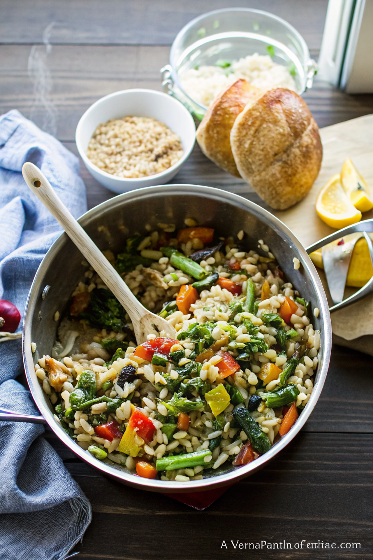 Beautiful finished Lemon Garlic Orzo with Roasted Vegetables served in a white bowl, garnished with fresh herbs and crumbled feta, showing the vibrant colors of the roasted vegetables mixed with golden orzo pasta