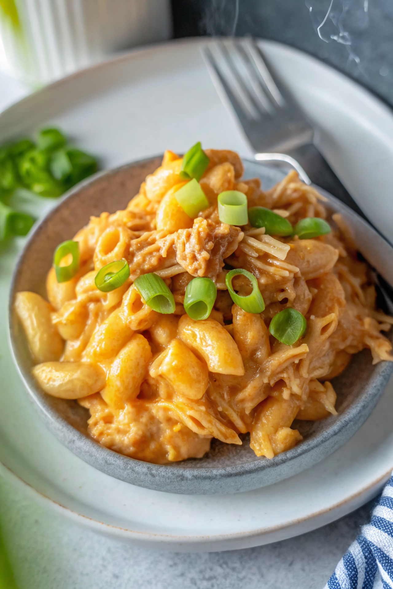 Final plated Slow Cooker Buffalo Chicken Mac and Cheese in a rustic bowl with garnish and styling