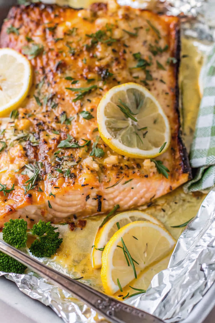 Beautifully plated Baked Honey Garlic Salmon with golden caramelized glaze, garnished with fresh herbs and lemon slices
