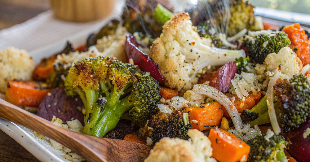 Beautifully plated Easy Garlic Parmesan Roasted Vegetables arranged on a white ceramic plate with golden caramelized edges and fresh parsley garnish